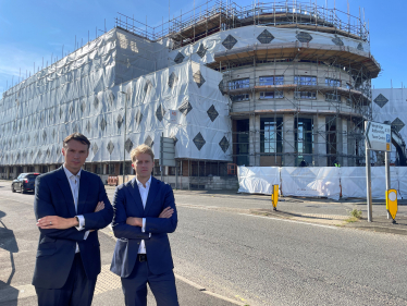 Cllr Tom Gracey and Dr Ben Spencer MP outside the proposed asylum seeker accommodation in Chertsey